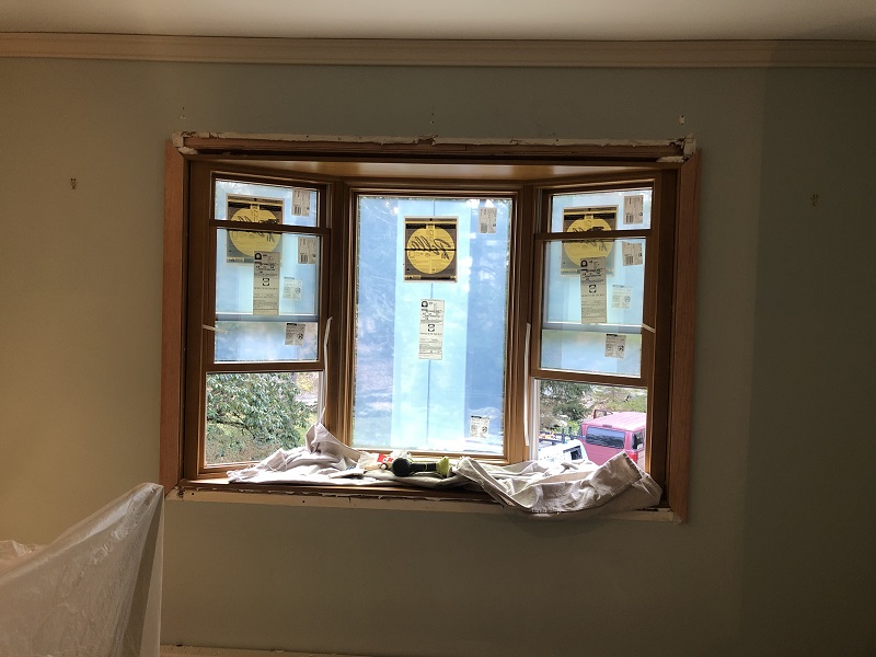 Interior trim being installed on a Pella bay window